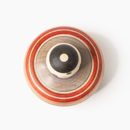 Top view of the Makoto-style Ejiko kokeshi in red and indigo