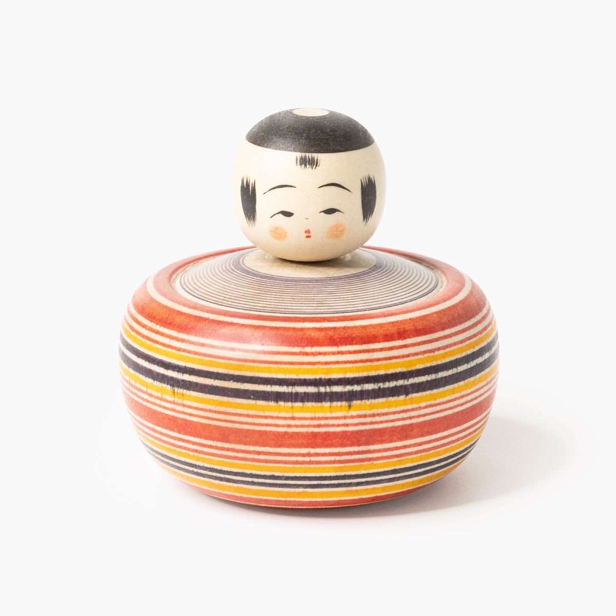 Front view of the Makoto-style Ejiko kokeshi in red and indigo