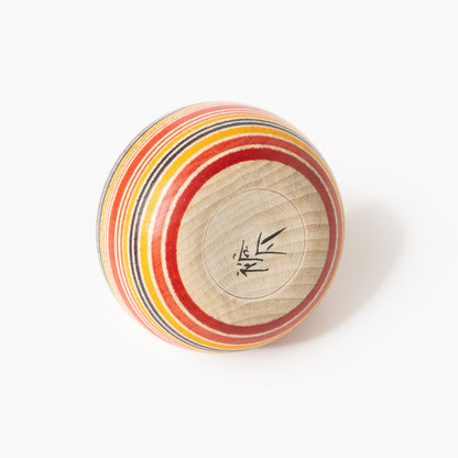 Underside of the red and indigo Ejiko kokeshi with artist’s signature