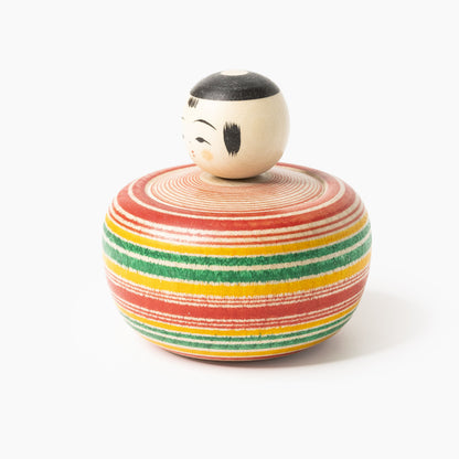 Side view of the Makoto-style Ejiko kokeshi in red and green